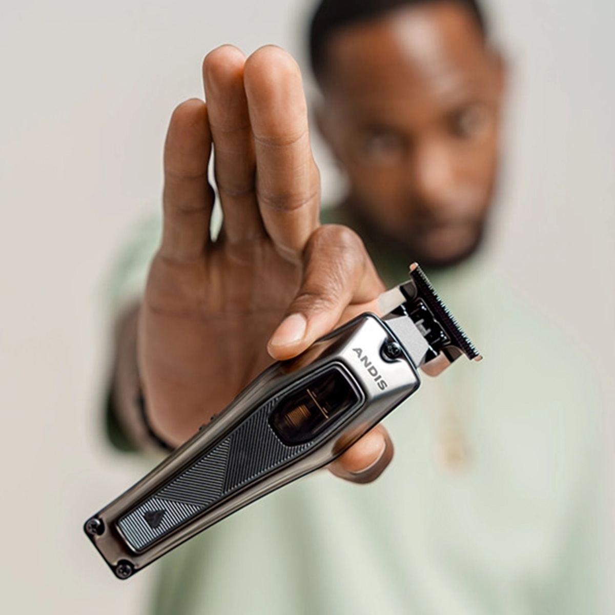Person holding the Andis Recon Trimmer 